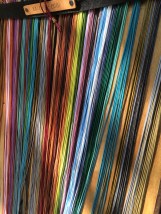 A rainbow of thin leather thongs at Forcalquier market